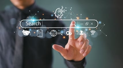 Image of person touching a search bar with AI and related icons